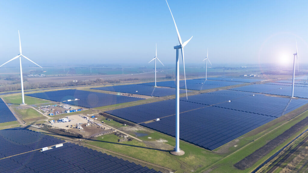 Eekerpolder solar farm in the Netherlands photographed from above. You can see the large-scale solar park and wind turbines.